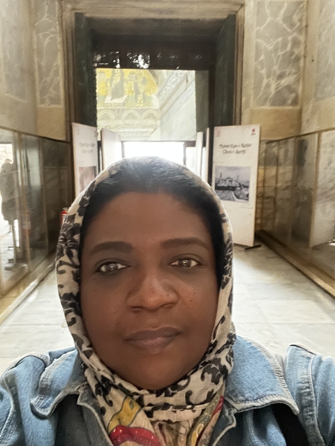 Person taking a selfie inside a museum or historical building.