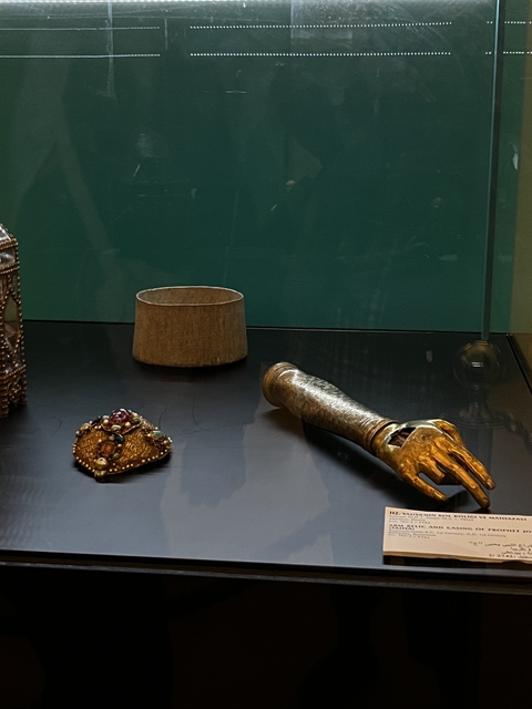 Antique items displayed in a glass case inside a museum.