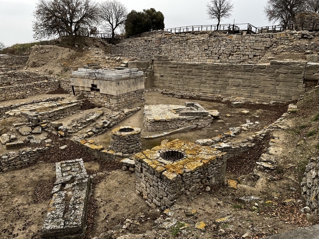       Ruins of an ancient stone structure in an archaeological site.
  