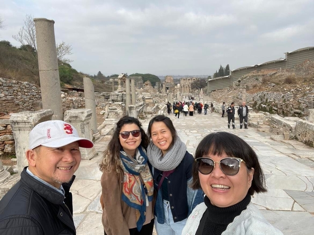 Group of people sightseeing at ancient ruins.