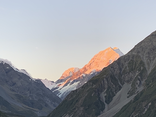       Sunlit mountains with snow caps.
  