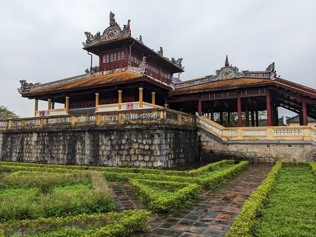       Historical temple building with a garden.
  