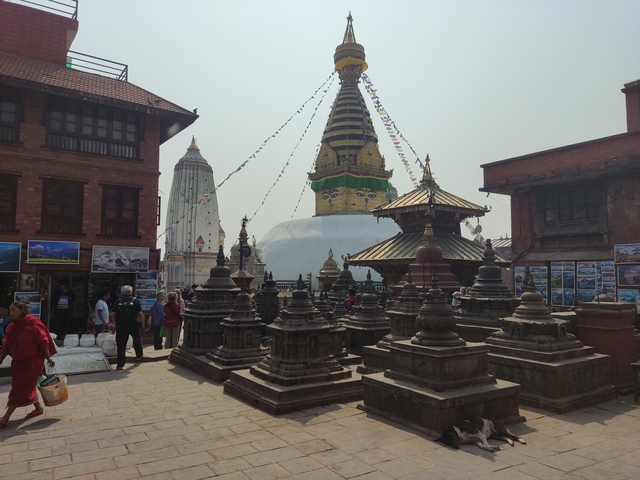       Temple complex with stupas and prayer flags.
  