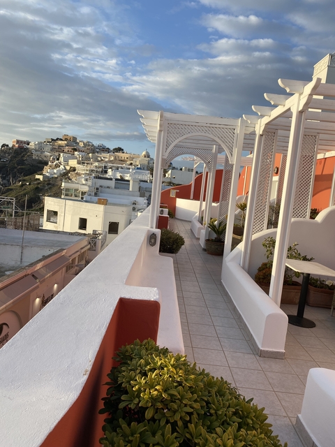 Whitewashed buildings with blue roofs on a bright day.
