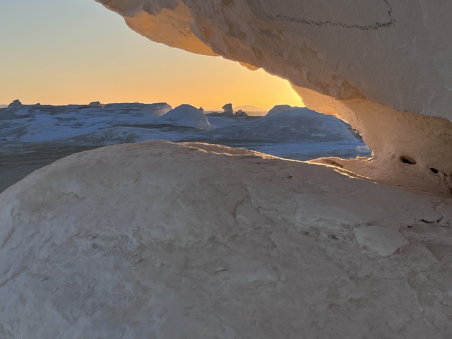 Sunset view through a natural rock window.