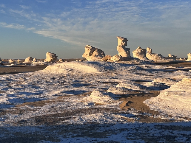 Desert landscape with unique rock formations at sunset.