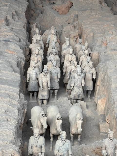 Terracotta Warriors on display with horses.
