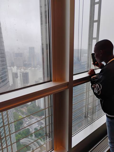       Indoor setting with a window view of a cityscape.
  