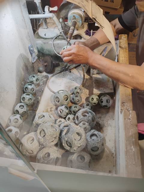       Person working with pottery at a craft station.
  