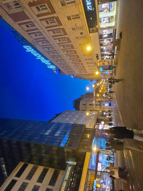 Cityscape with buildings and a clear blue sky inverted.