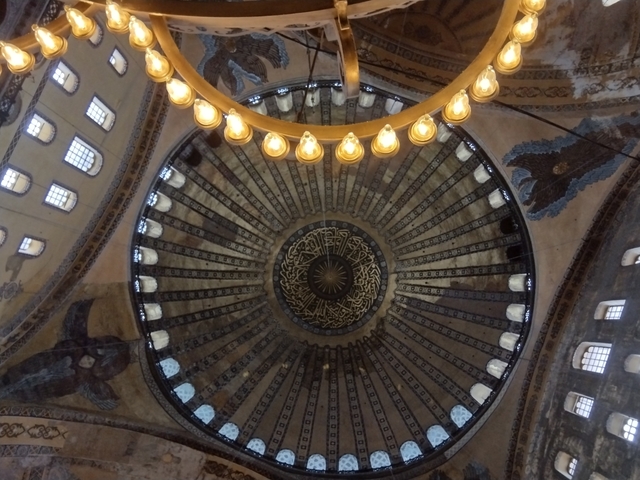       Intricately designed dome interior with hanging lights.
  