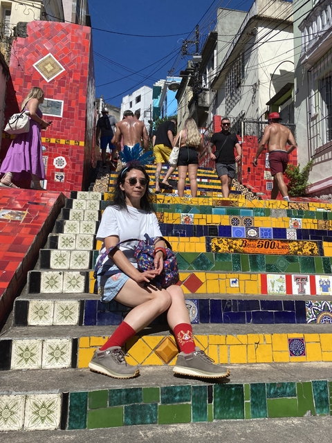       Woman sitting on colorful steps.
  