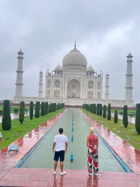 Couple walking toward the Taj Mahal.