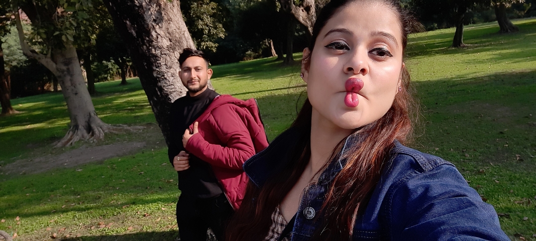       Couple making funny faces in a park
  