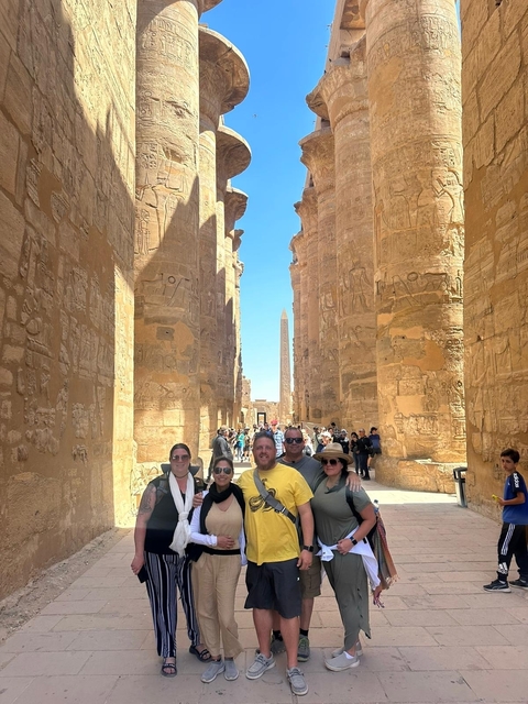 Group of people standing in an ancient Egyptian temple.