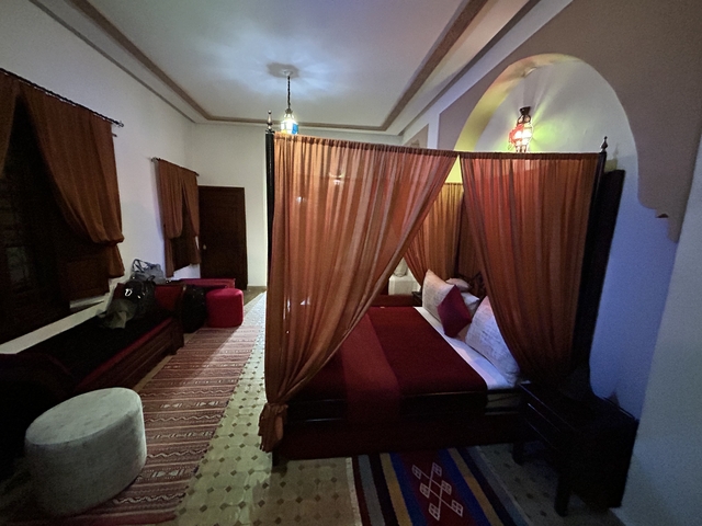       Interior of a traditionally decorated room with a canopy bed.
  