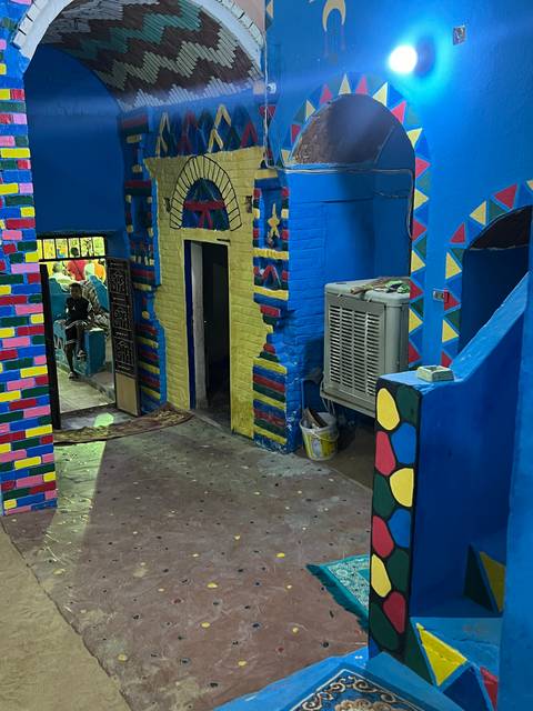       Colorful interior wall with vibrant decorations and patterns.
  