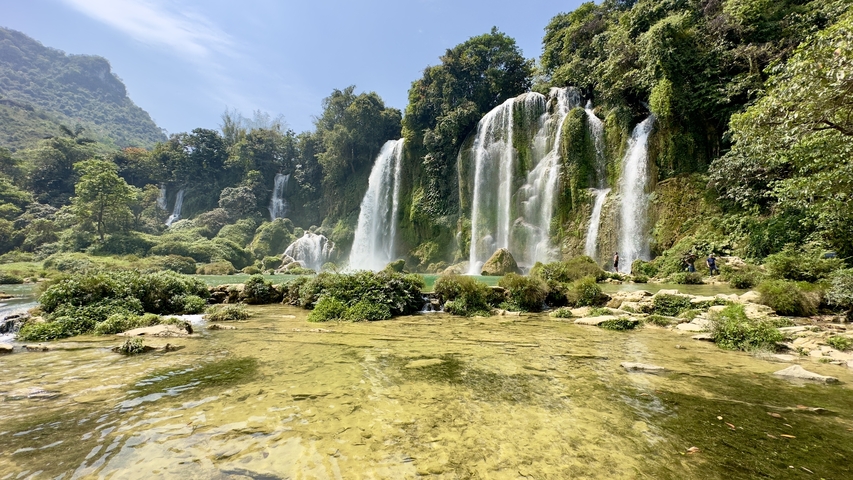       Waterfalls surrounded by lush vegetation.
  