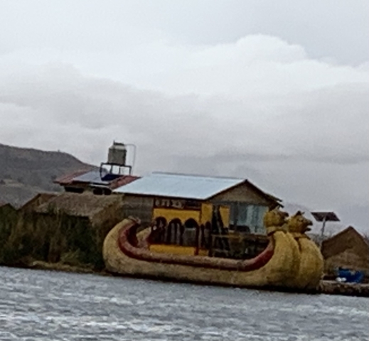 Blurry image of a boat near a house on a lake.