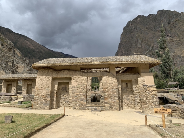       Ruins in front of mountainous landscape.
  