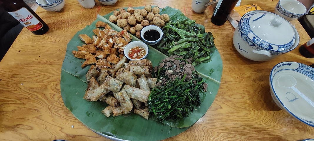 Assorted traditional Vietnamese food dishes on a banana leaf.