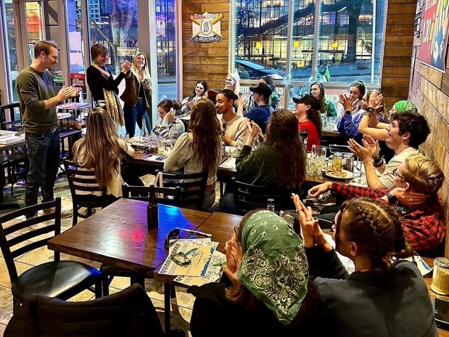 People in a restaurant applauding or interacting.