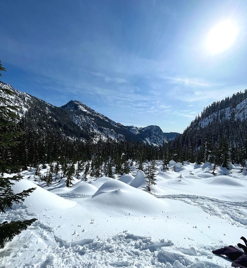 Snowy mountain landscape with a clear blue sky.