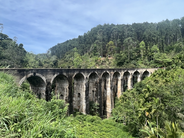 Nine Arches Bridge surrounded by lush greenery.