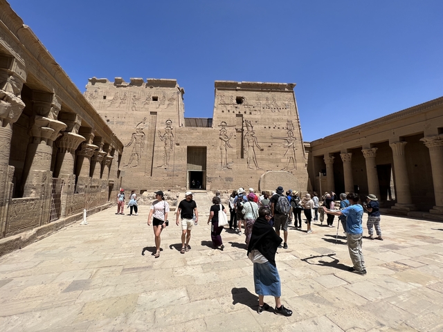       Ancient temple courtyard filled with tourists.
  