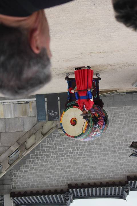 Traditional drum performance with a crowd watching.
