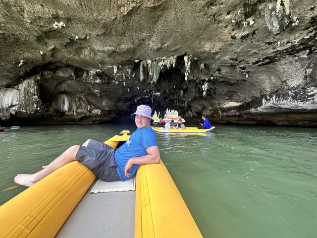       Individuals in kayaks inside a cave.
  