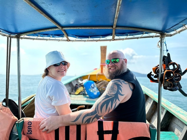       Couple sitting on a boat in the sea.
  