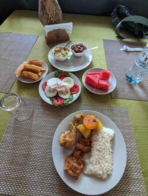 Variety of dishes served on a table including watermelon and salad.