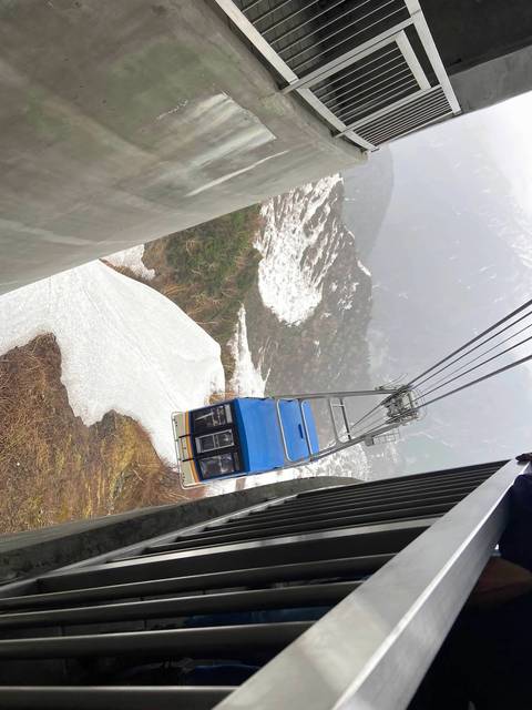 Cable car with misty snowy landscape.