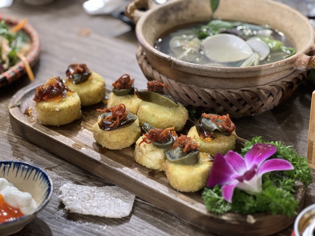 Plated gourmet dishes with decorative garnishes.