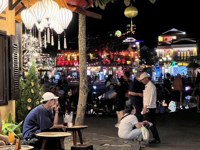 Bustling night market with vibrant lights and decorations.