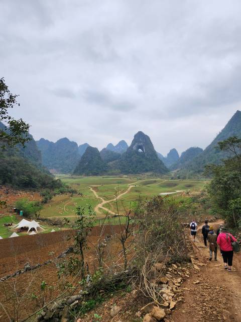       Open landscape with mountains and a path.
  
