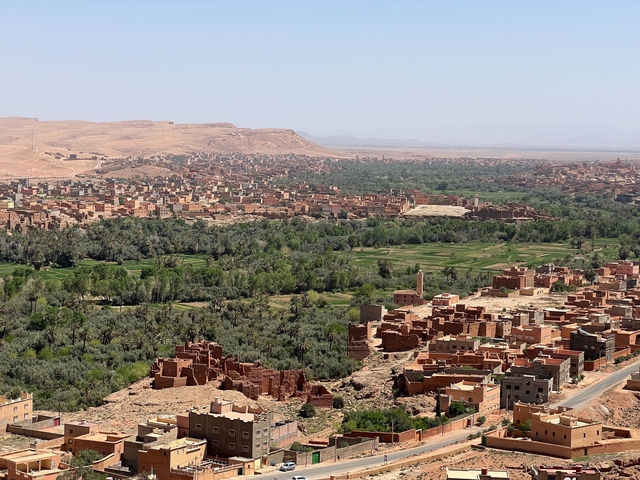Vast landscape of a Moroccan town with fields and houses.