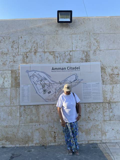       Map of Amman Citadel with a person standing in front.
  