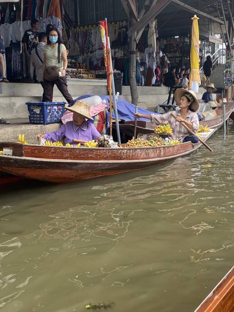 Floating market scene with vendors and boats.