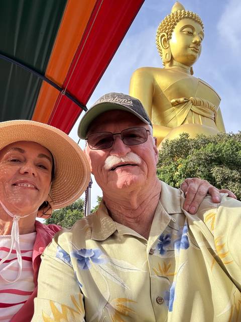 Selfie with a large Buddha statue in the background.