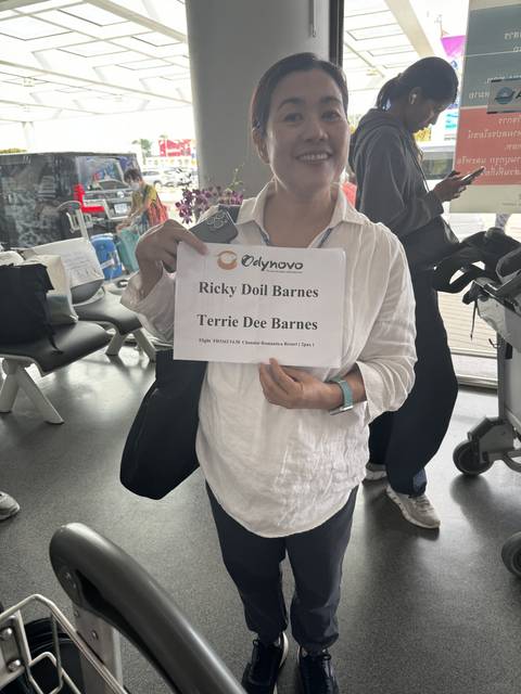 Person holding a sign at an airport.