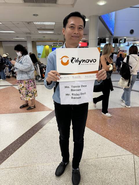 Person holding a sign at an airport.