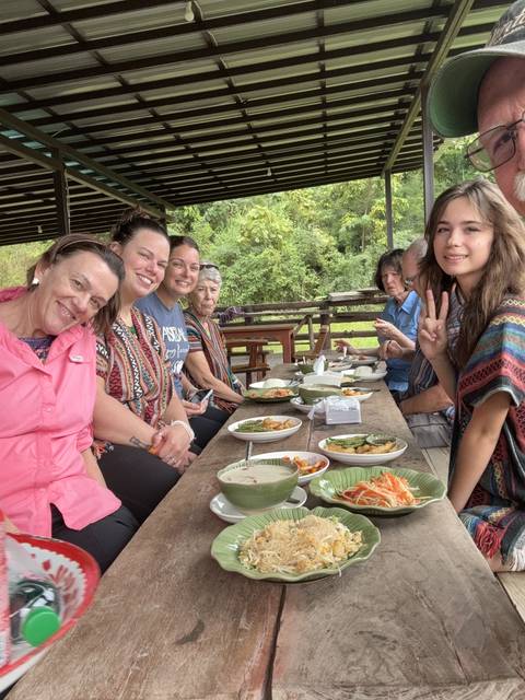       Group of people enjoying a meal together.
  