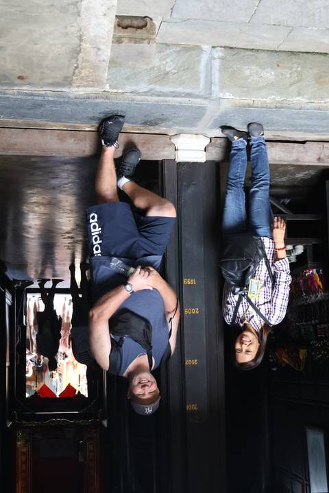 Two people posing in front of a building.