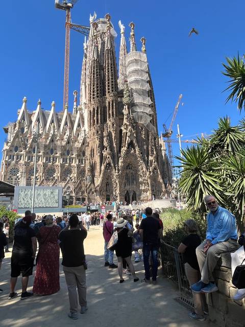       Tourists visiting a famous unfinished basilica.
  