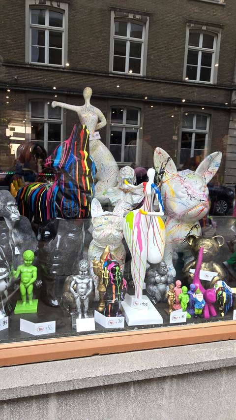       Shop window displaying colorful figurines.
  