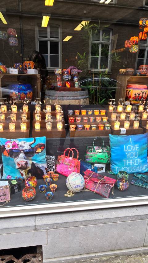       Shop window display with colorful bags and knick-knacks.
  