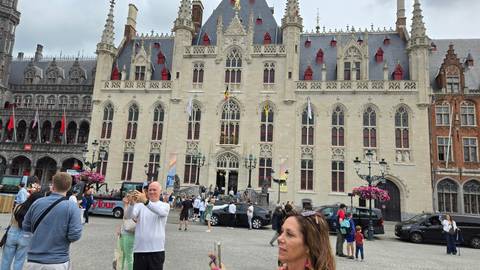       Upside-down image of a historical building with people in front.
  