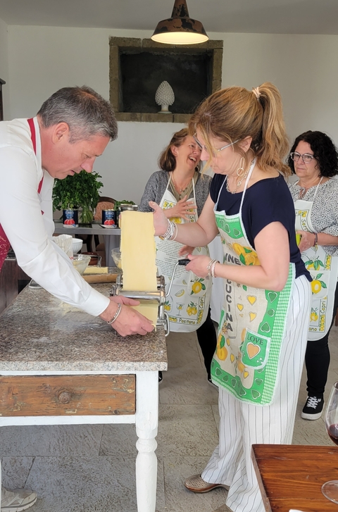 People making pasta with a pasta machine.
